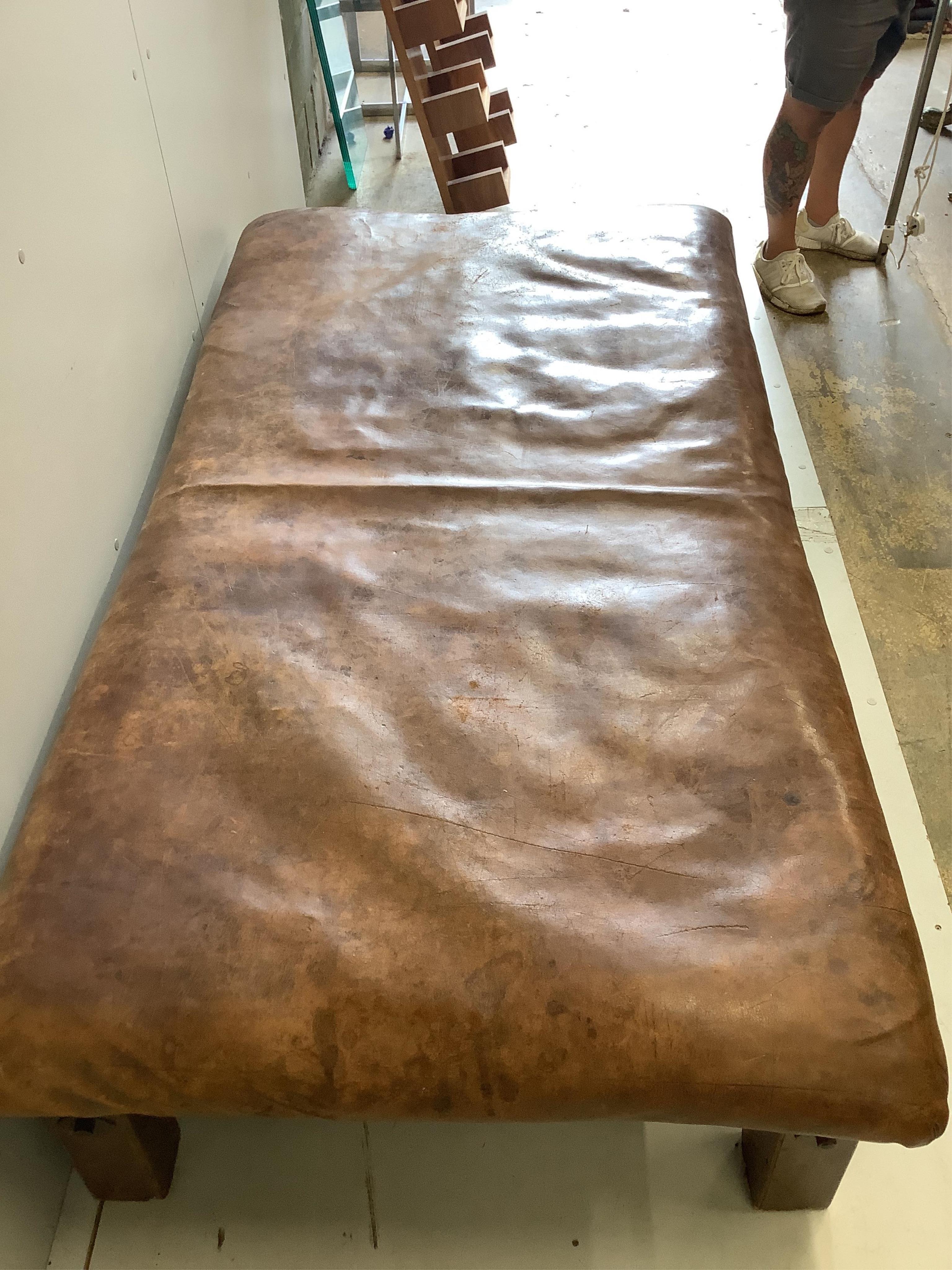 A Contemporary rectangular brown leather stool, width 178cm, depth 90cm, height 50cm. Condition - fair